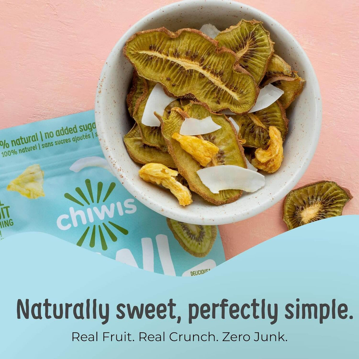 Tropical Chips made from real fruit, including kiwi and coconut, in a bowl on a pastel background.